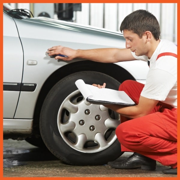 Man Inspecting Car