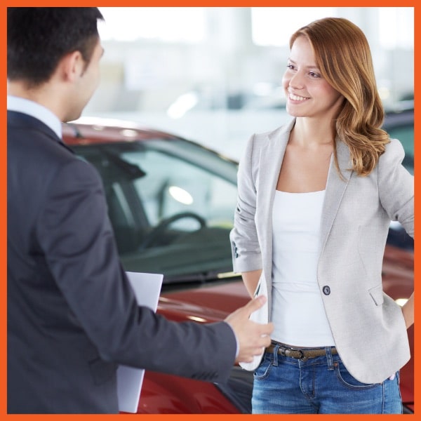 Woman Buying New Car at Dealer