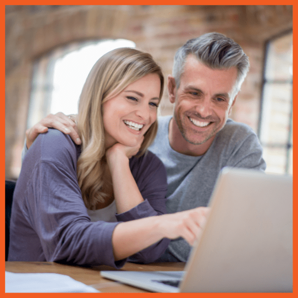 Speed and Efficiency - Man and Woman Smiling at Laptop